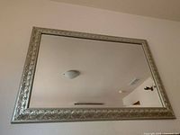 Full view of rectangular mirror mounted on wall