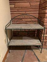 Front view of wine rack showing two marble shelves and metal frame