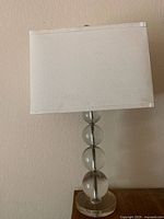 Full view of lamp showing shade and glass sphere column