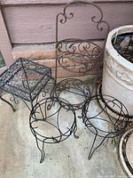 All four metal plant stands grouped together