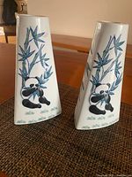 Front view of both ceramic vases showing panda and bamboo artwork