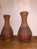 Two wicker floor vases full view