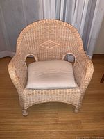 Front view of wicker armchair with cushion