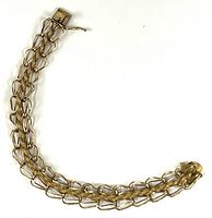 Full view of gold bracelet showing clasp and overall design