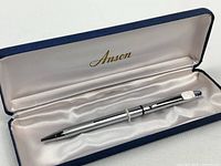 Pen inside open Anson branded case