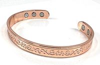 Full view of copper cuff showing scroll design