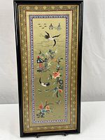 Full view of framed embroidered panel