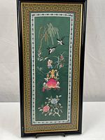 Full view of framed embroidery artwork