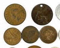 Assorted copper coins showing George VI portrait and Britannia design
