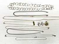 Full view of eight necklaces/chains, earrings, pendant