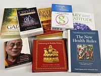 Group shot of all eight items: four oracle card decks and four books