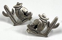 front view of both sterling silver earrings showing sleeping man and cactus design