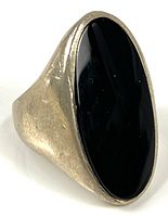 Front angled view of sterling silver ring with oval black onyx stone