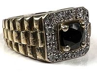 Front view of ring showing sapphire, bezel and accent stones