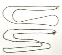 Both sterling silver necklaces laid out flat