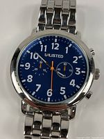 Front view showing blue dial, numerals, hands