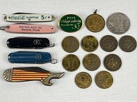 Group shot of all five pocket knives and twelve tokens