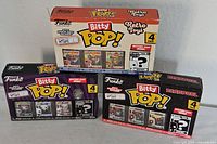 All three sealed Funko Bitty Pop! 4-pack boxes displayed