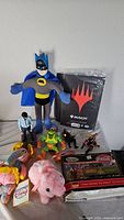 Overall lot view with plush toys, action figures, Magic binder and die-cast set