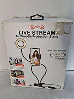 Front of box showing Primo Live Stream Multimedia Production Stand with ring light and phone holder