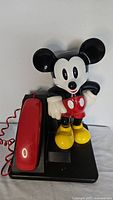 Front view of Mickey Mouse telephone showing figure, base and handset