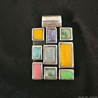 Front view showing silver frame and colored stone inlays