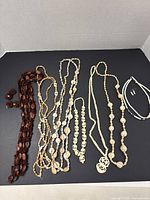 Full lot view showing all necklaces and earrings