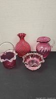 Group shot of all four cranberry glass pieces