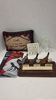 All items in lot overview: pillow, gloves, sign, figurine, wooden club display
