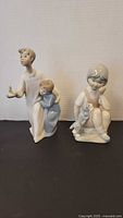 Both porcelain figurines front view