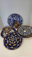 Five Talavera plates front view showing designs