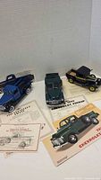Three Danbury Mint diecast pickup trucks with paperwork