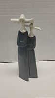 Front view of Nao porcelain figurine showing two nuns