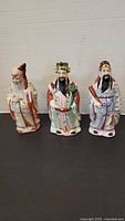 Front view of all three porcelain figures