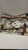 Folded quilt showing patchwork front fabrics