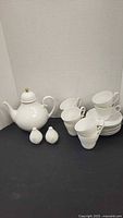 Full tea set including teapot, cups, saucers, salt and pepper shakers