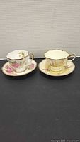 Two teacup and saucer sets side by side