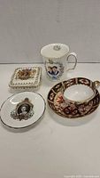 Group shot: teacup, saucer, commemorative mug, square coaster, round dish