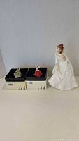 Large "Barbara" figurine and two miniature ladies on boxes