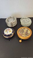 All items together: stack of four sterling-rimmed glass coasters, Limoges trinket box, Hummel music box