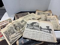 Spread of assorted vintage newspapers showing covers including coronation souvenir, royal tour, daily telegraph funeral supplement
