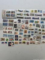 Overall view of spread of mint Canadian stamps including miniature sheet and numerous singles