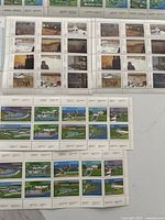 Overview of two 32¢ stamp panes with rural and winter scenes plus one 32¢ civic landscape pane