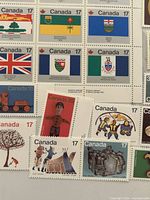 Partial pane of 17¢ Provincial Flags stamps with assorted 17¢ commemoratives