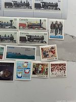 Assorted 32¢, 37¢ and 64¢ singles including trains, pottery, volleyball and others