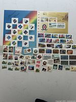 Overview of all mint Canadian stamps including two souvenir panes and loose stamps