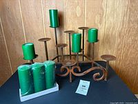 Candleholder with some candles and shrink-wrapped candle set