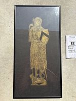 Full view of framed brass rubbing artwork