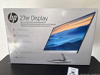 Front of sealed HP 27er monitor box showing product image and branding