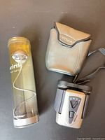Nikon binoculars with strap, Nikon case, Brookstone Wink flex-light in tube